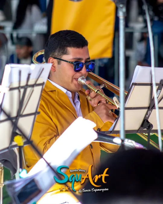 Trombonista de la banda con la chaqueta mostaza del uniforme